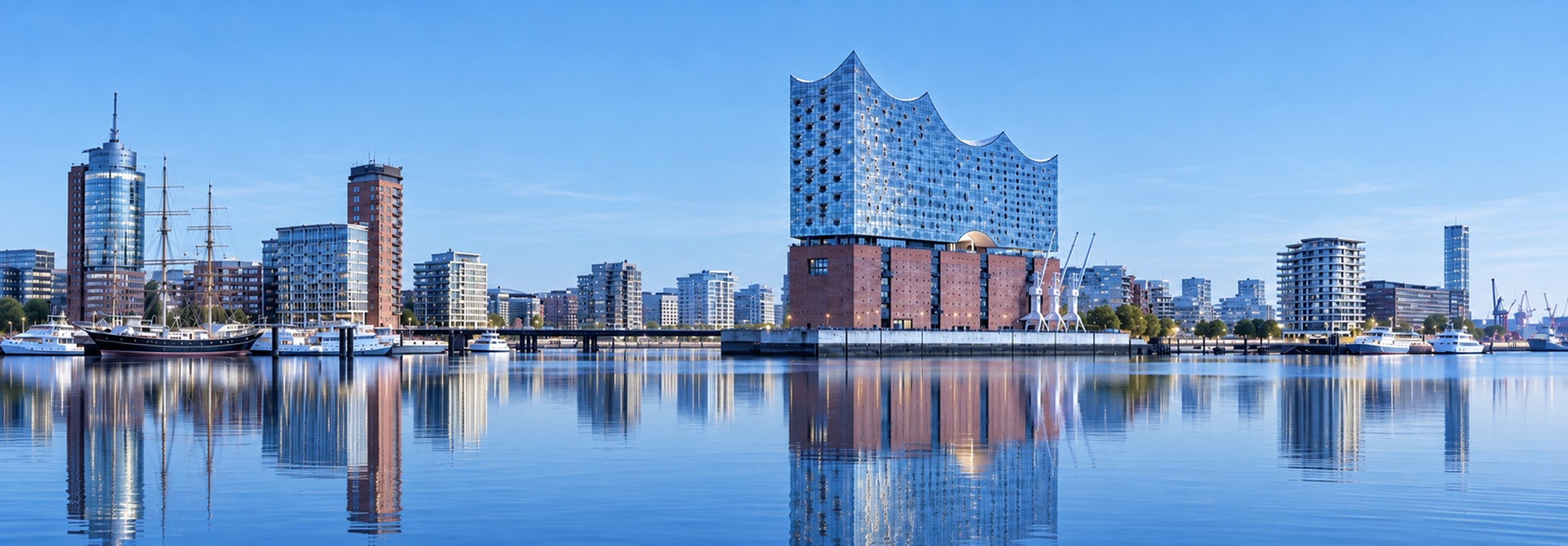 HafenCity at Strandkai with historic harbour cranes and modern architecture